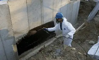 Professional waterproofing the exterior walls of the basement in Arlington, TX