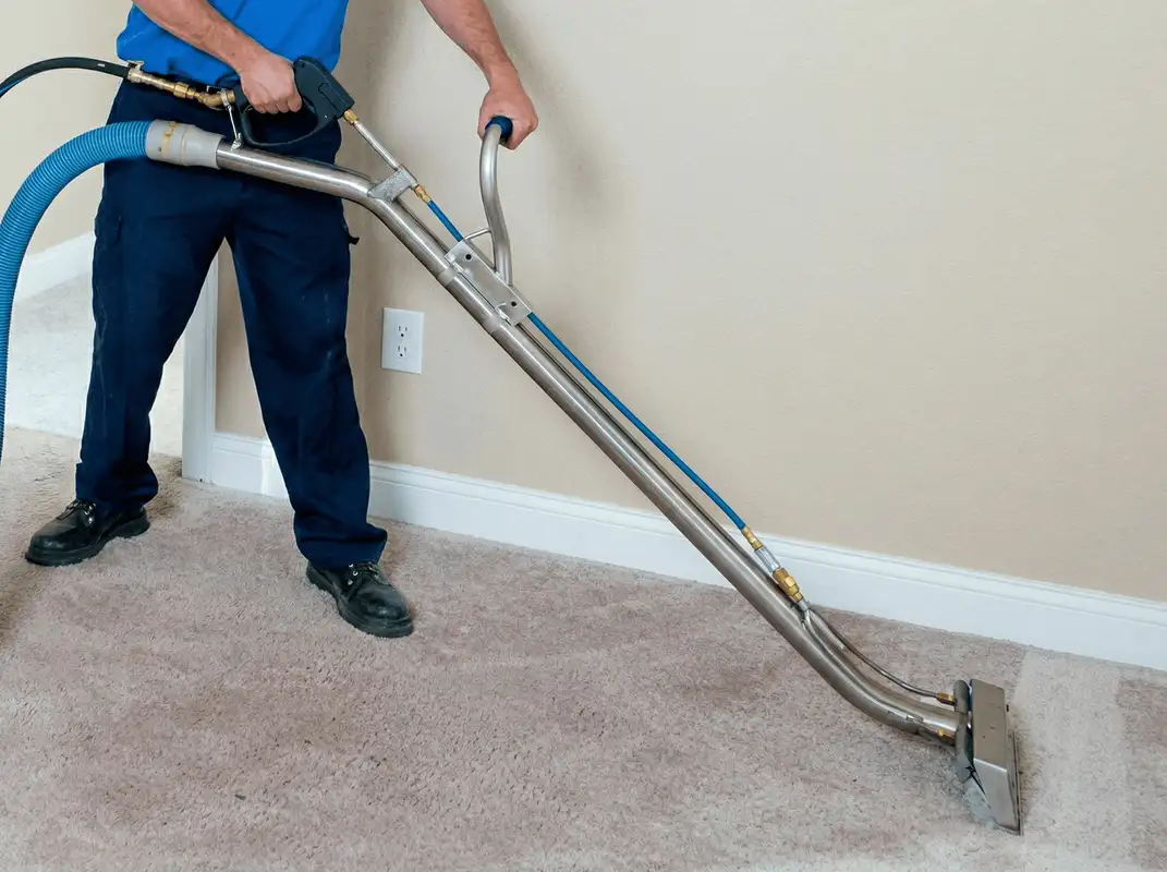 Professional operating a liquid removal machine on a carpeted floor in Arlington, TX