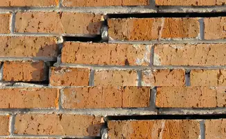 Brick wall with serious structural damage in Arlington, TX